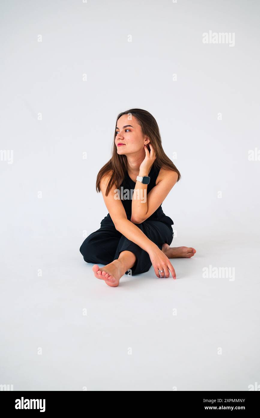 young girl sitting on the floor and looking away Stock Photo - Alamy