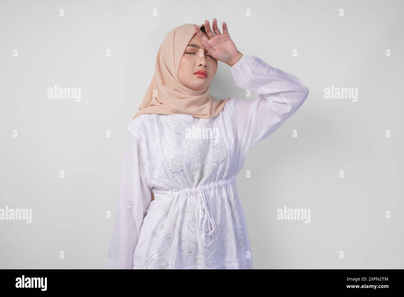 Sad Asian Muslim woman in hijab looks stressed and depressed or 