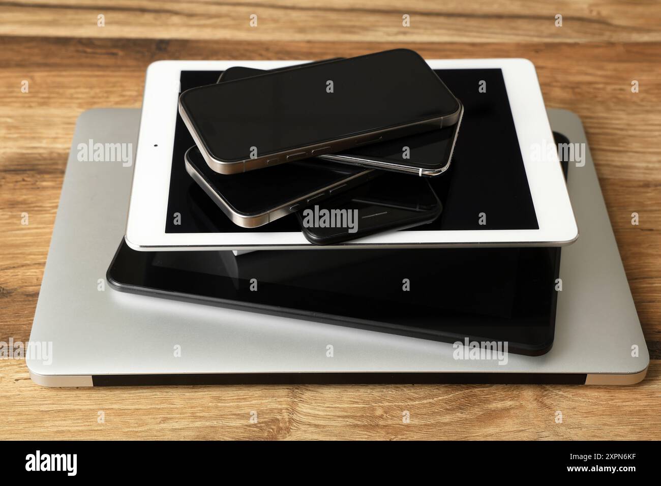 Stack of modern gadgets on wooden table Stock Photo