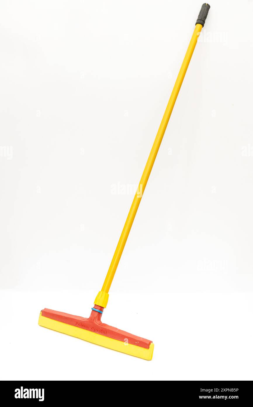 Yellow and Red Floor Squeegee with Handle Isolated on White Background Stock Photo