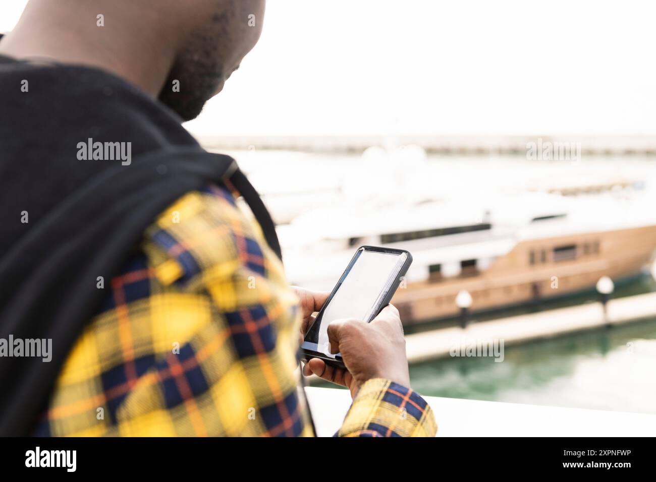 unrecognizable black man consulting his smartphone Stock Photo