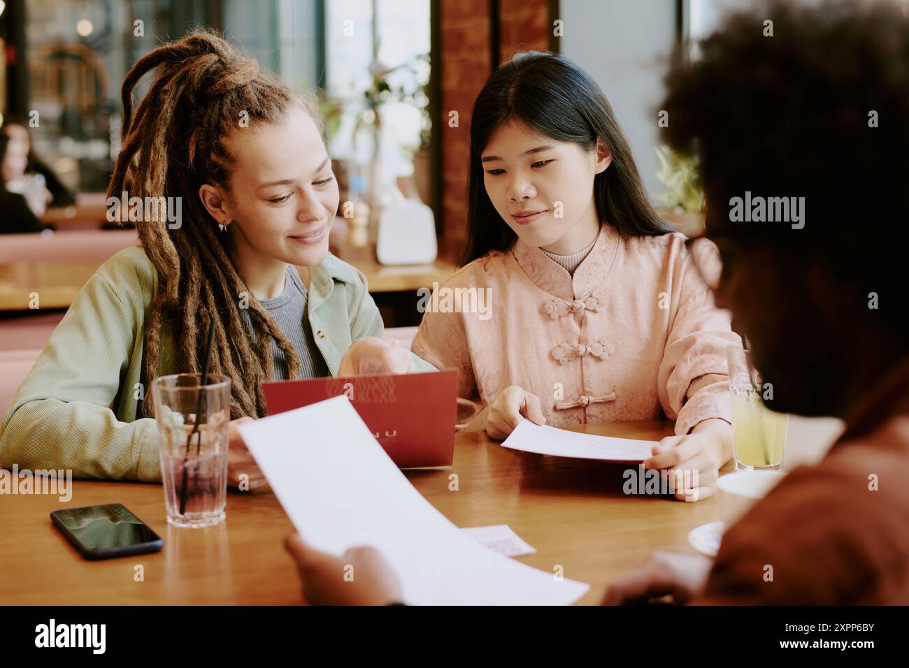 Collaborating in Modern Asian Fusion Restaurant Stock Photo