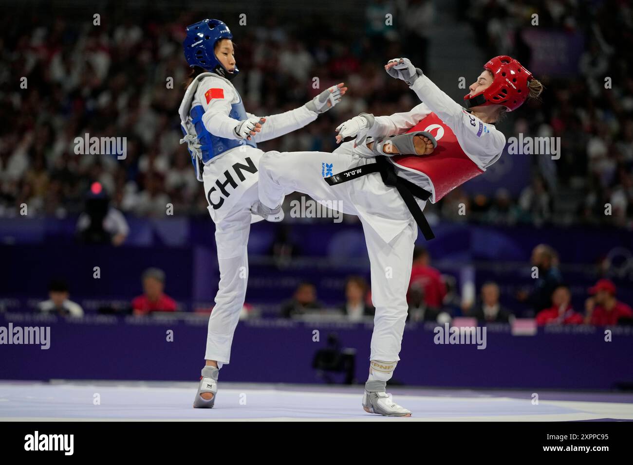 China's Guo Qing competes withTurkey's Merve Dincel Kavurat in a women ...