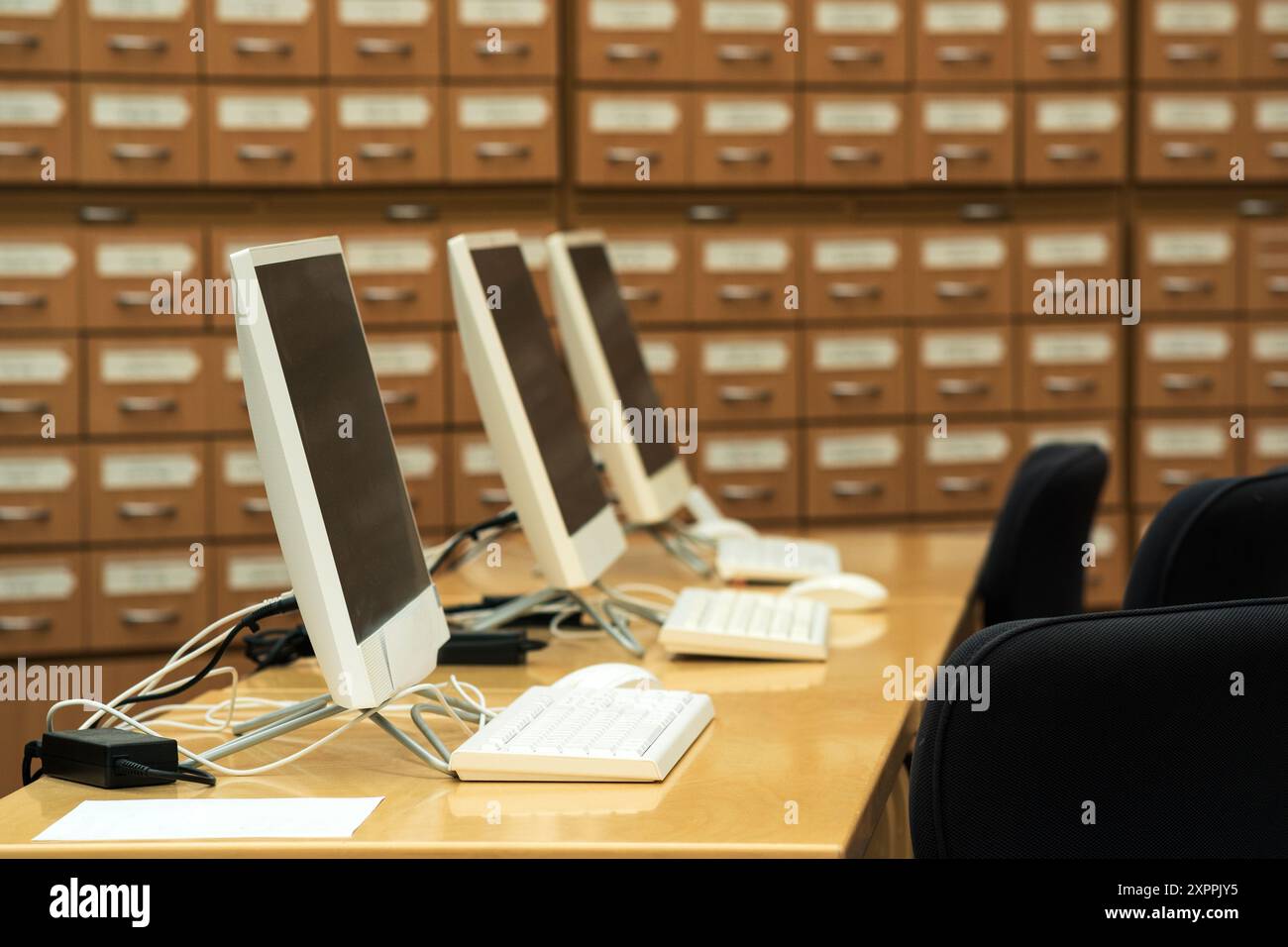 computer terminals in a modern library with blurred catalog cabinets in ...