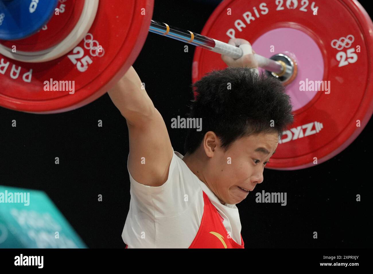 Hou Zhihui of China competes during the women's 49kg weightlifting ...