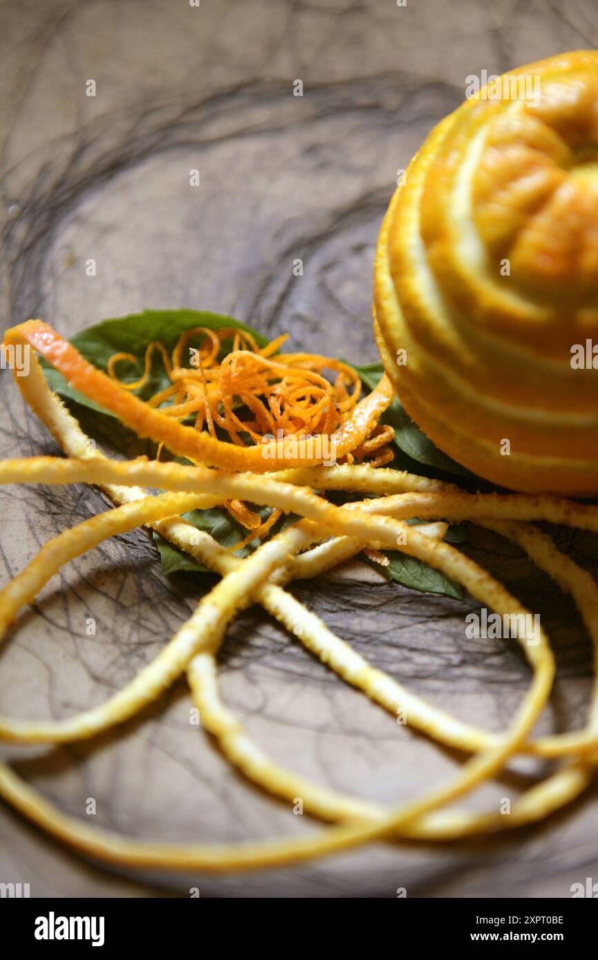 Prepared dish with orange fruit in clay dish Stock Photo