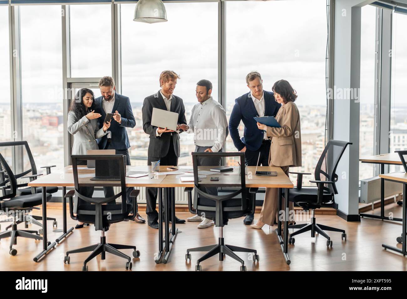 Business Professionals Collaborating In Modern Office With City View Stock Photo