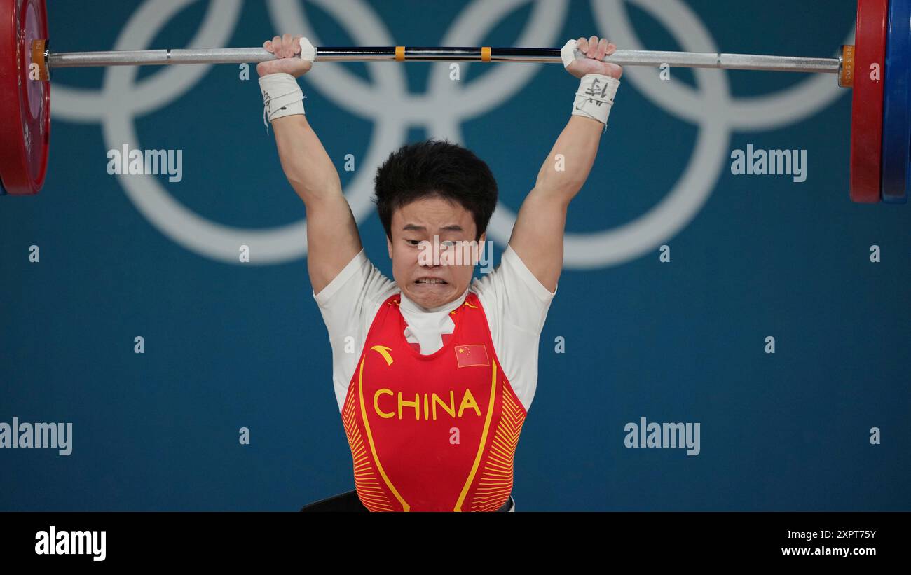 Hou Zhihui of China competes during the women's 49kg weightlifting ...