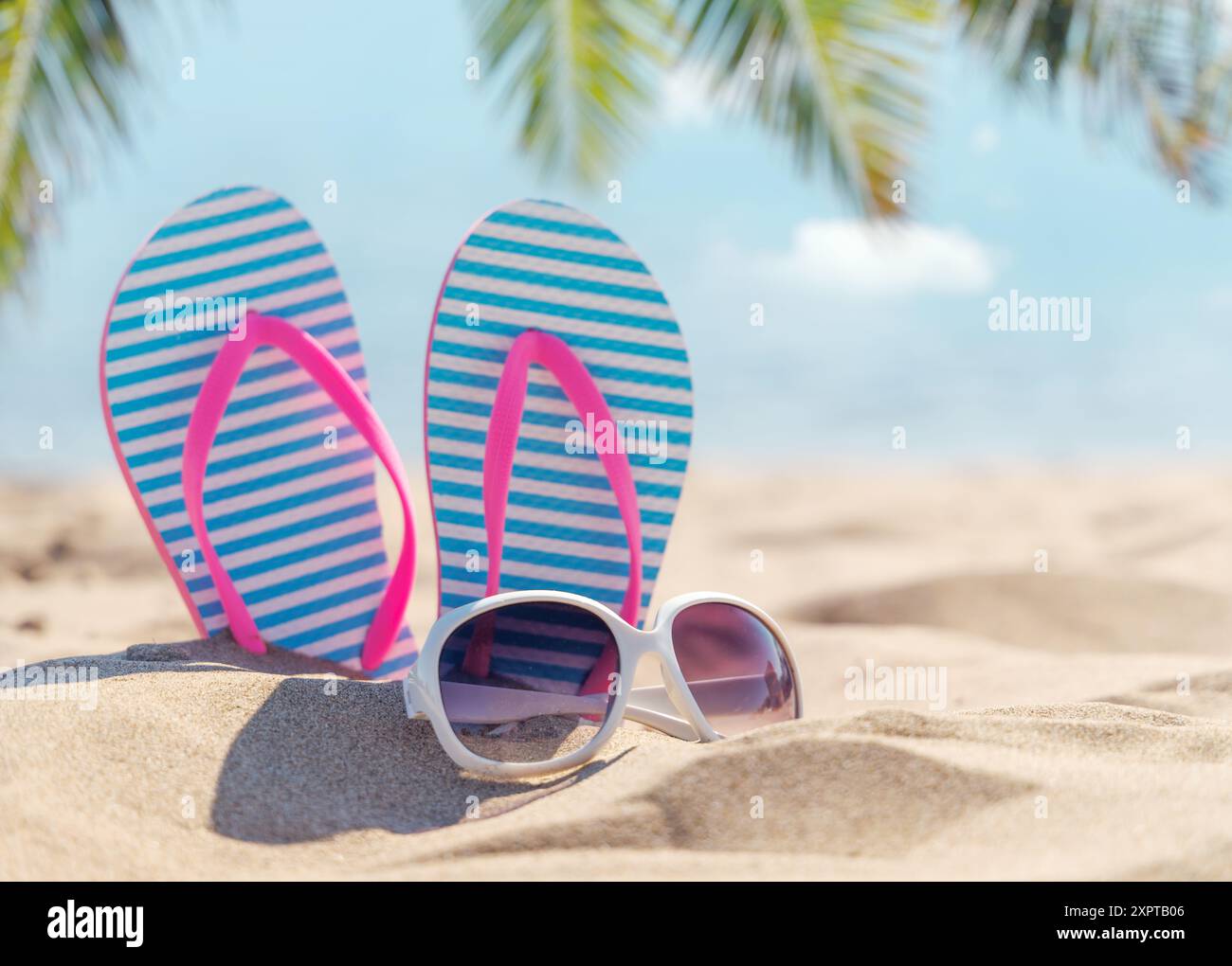 Flip flops and shades on the sea beach, summer vacation Stock Photo - Alamy