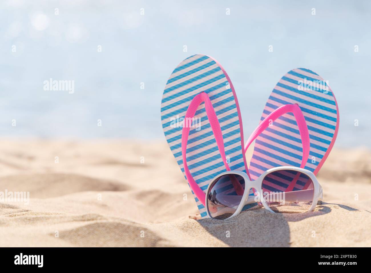 Flip flops and shades on the sea beach, summer vacation Stock Photo - Alamy