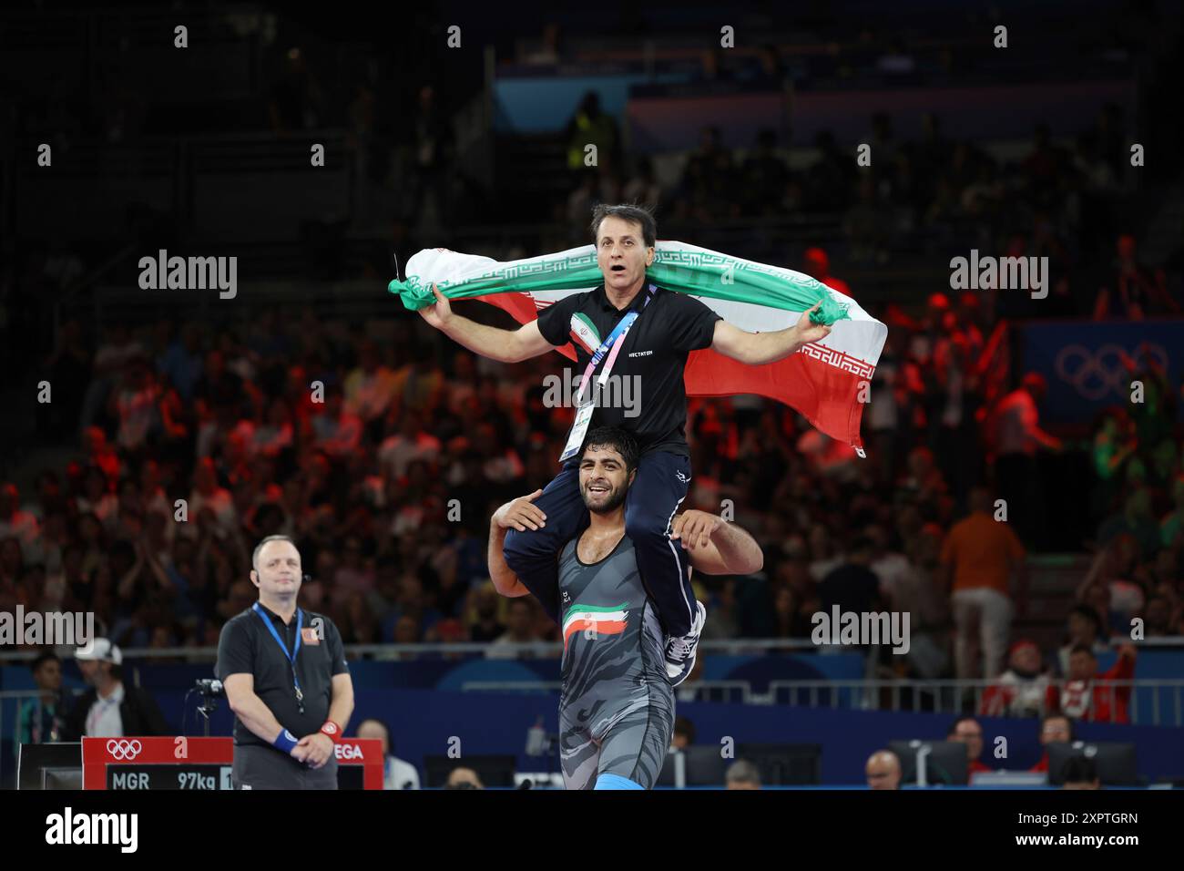 Iran's SARAVI Mohammadhadi with his coach celebrates after winning the ...