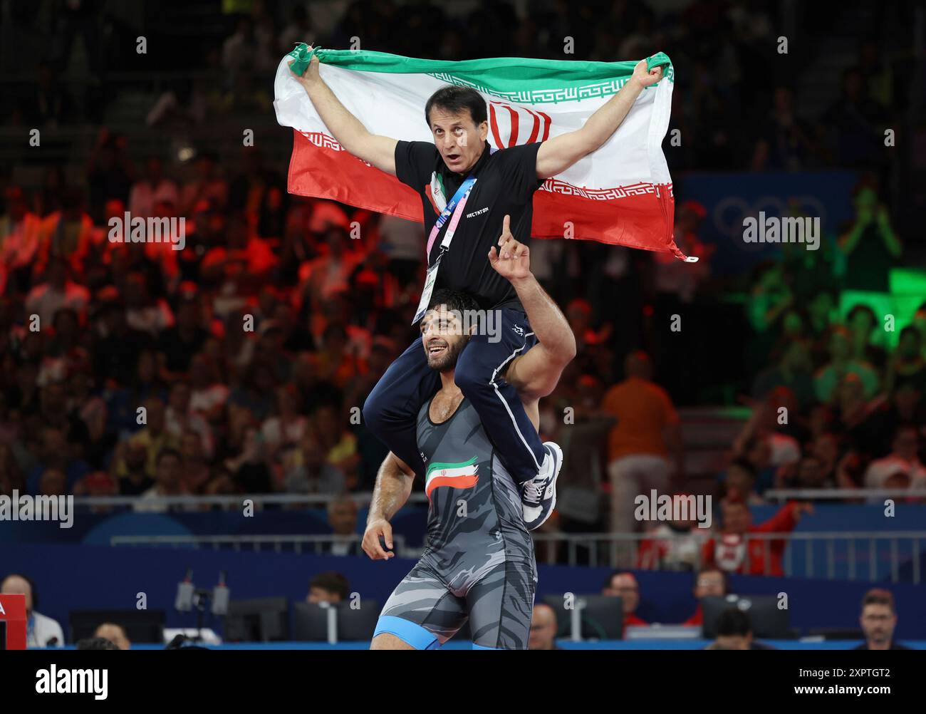 Iran's SARAVI Mohammadhadi with his coach celebrates after winning the ...