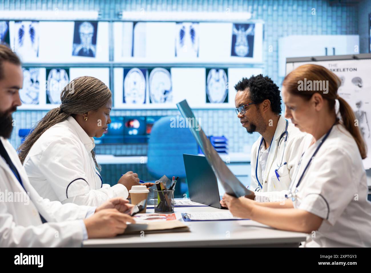 Doctors meet to discuss healthcare records and x ray scans results at a ...