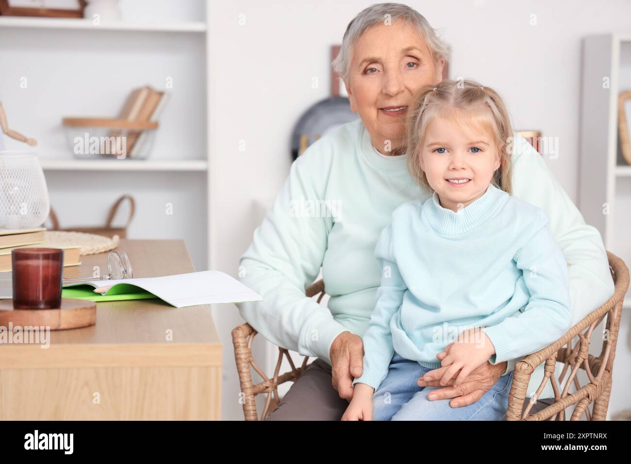 Cute little girl with her granny studying at home Stock Photo - Alamy