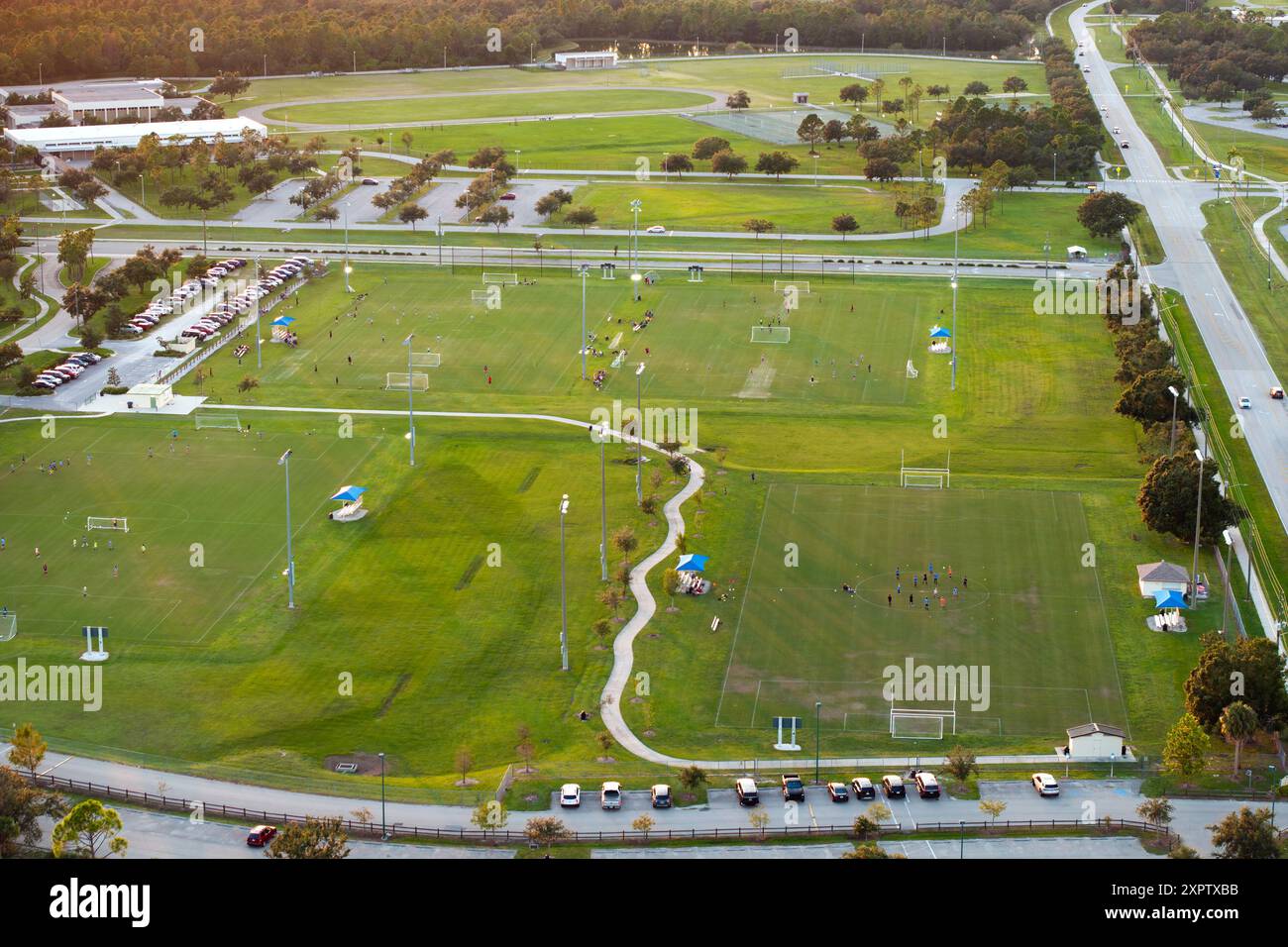 Aerial view of public sports park with children engaged in football ...
