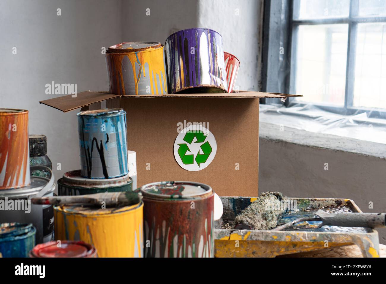 Old Paint Cans. Cans of colored paint. Oil-based enamel, lacquer, shellac and varnish leftovers. Household Hazardous Waste Stock Photo