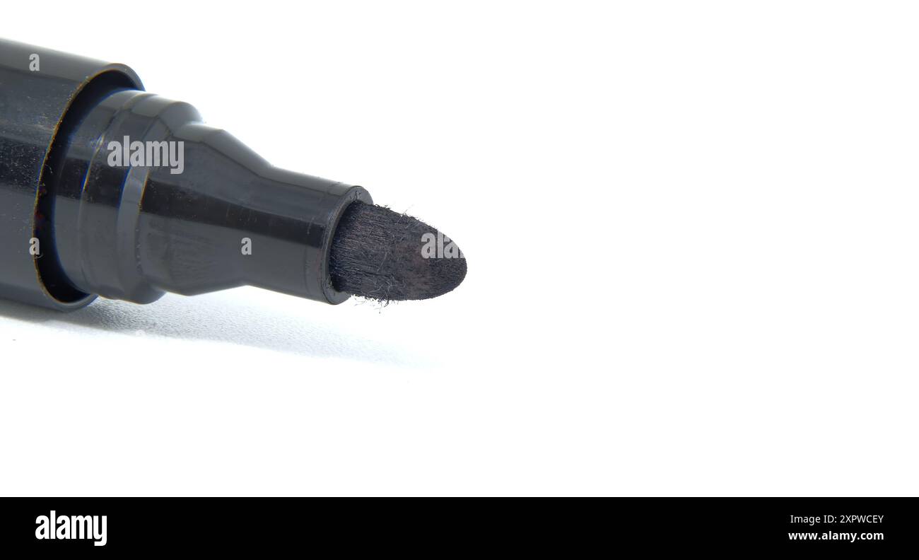 Detailed close-up of black permanent marker with white background. Ideal for office supplies, school projects, and art use. Stock Photo