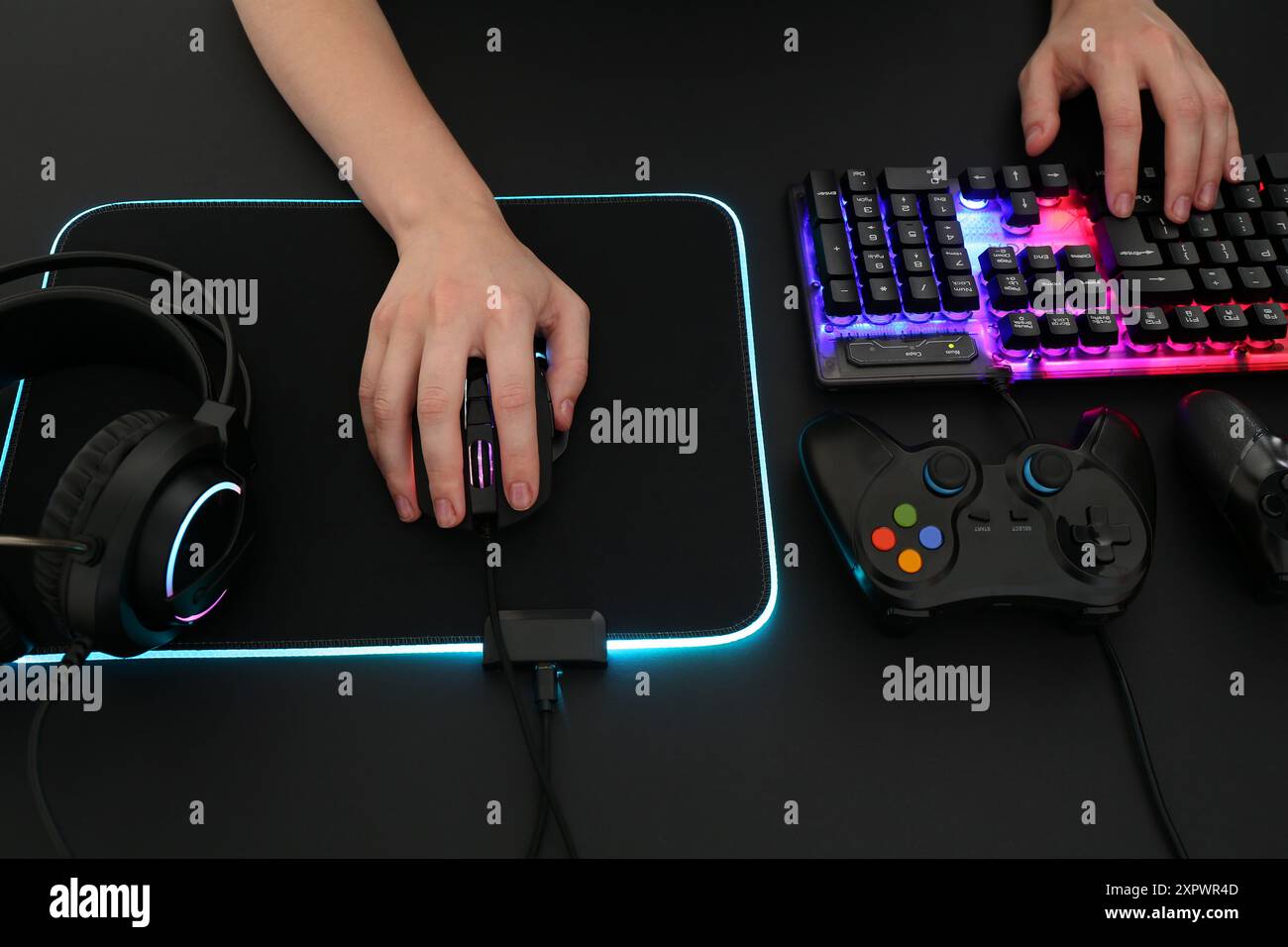 Gamer using modern wired computer mouse at dark table, above view Stock ...