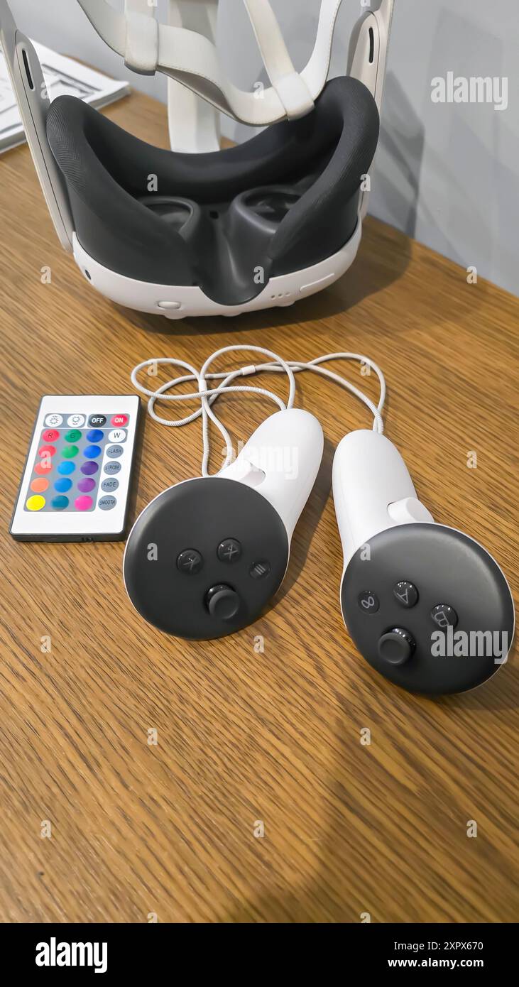 Virtual game set. VR headset. Glasses are on the table next to the control panel. Copy space Stock Photo