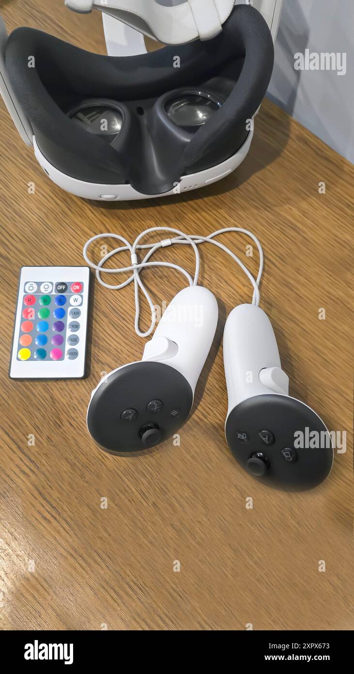 Virtual game set. VR headset. Glasses are on the table next to the control panel. Copy space Stock Photo