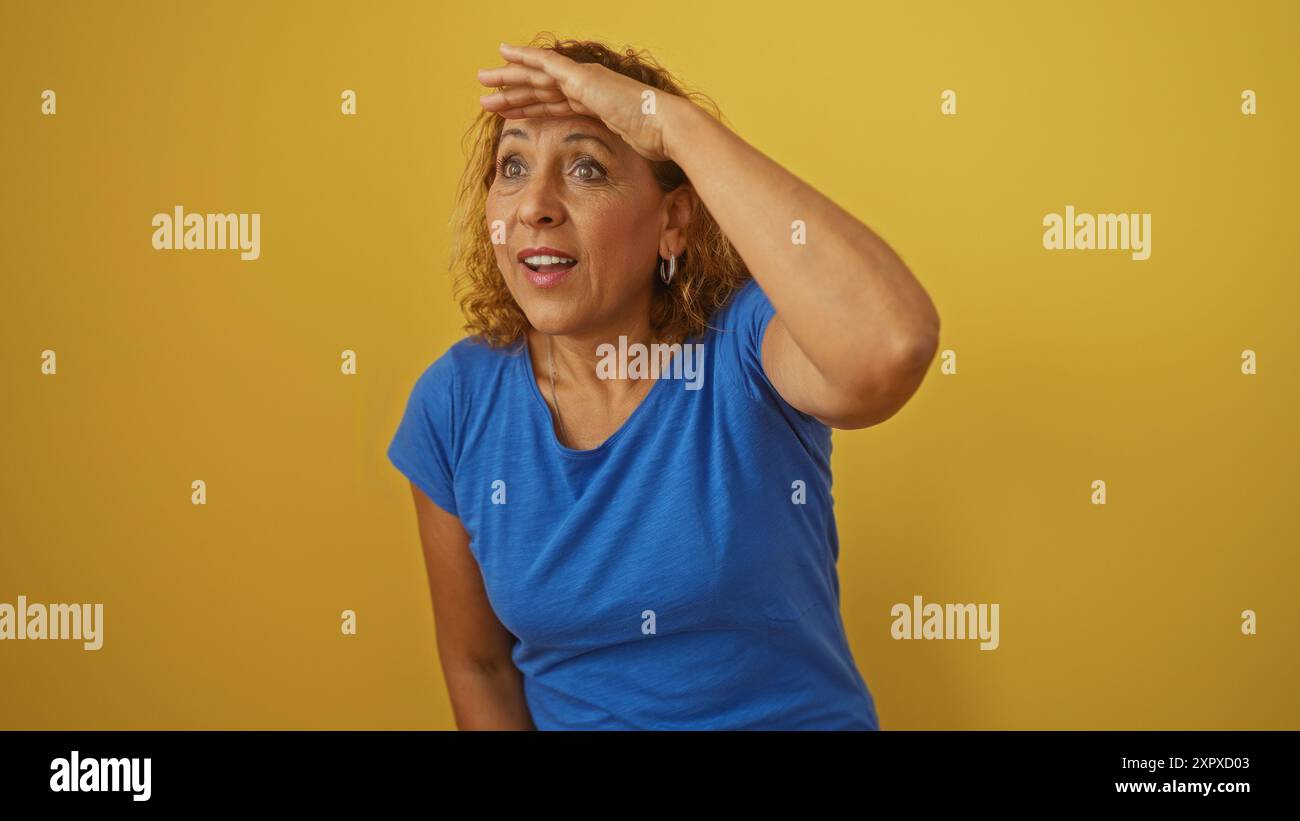 Elderly hispanic woman in a blue shirt with curly hair looking ahead ...