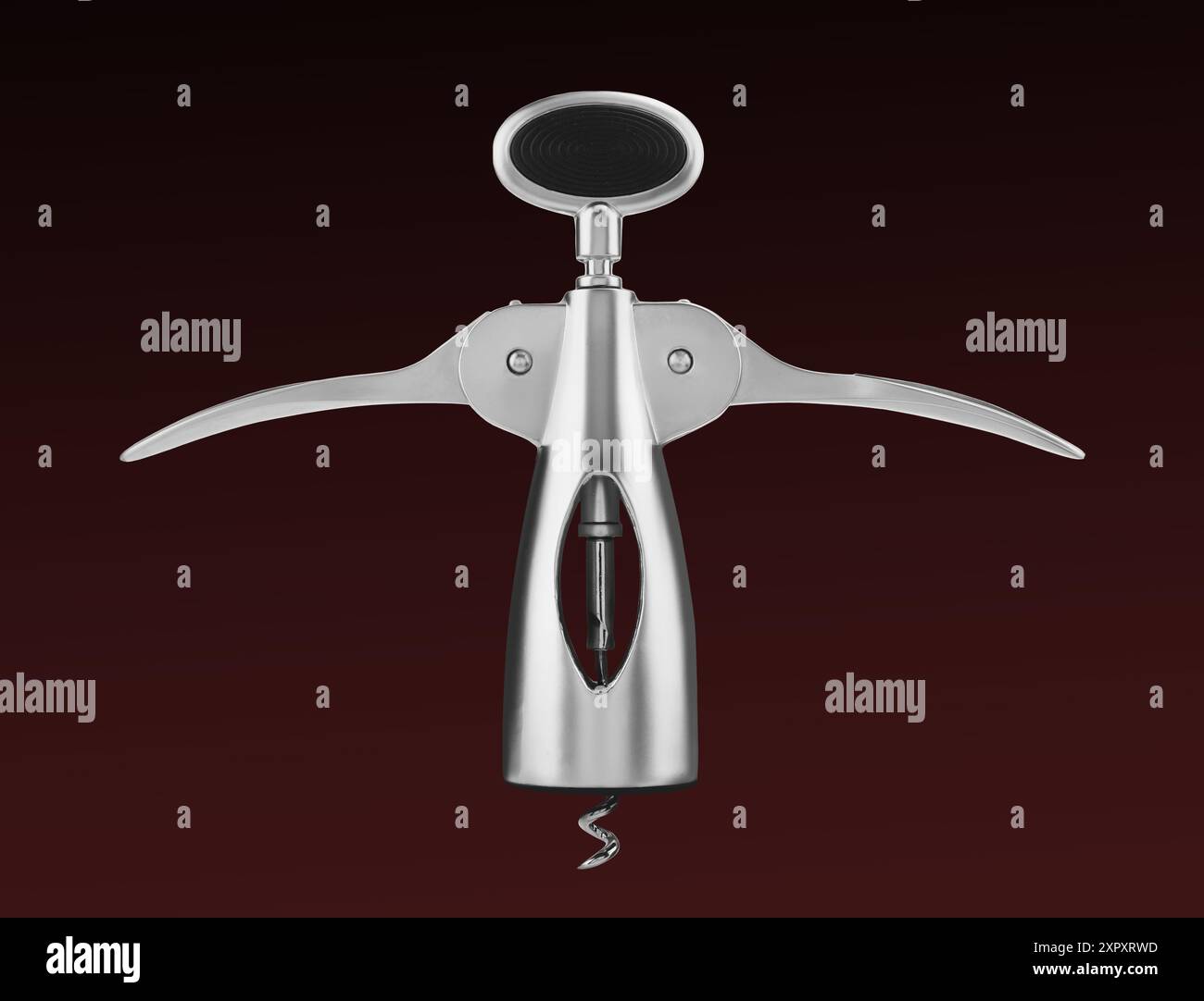 Winged corkscrew on dark red gradient background Stock Photo