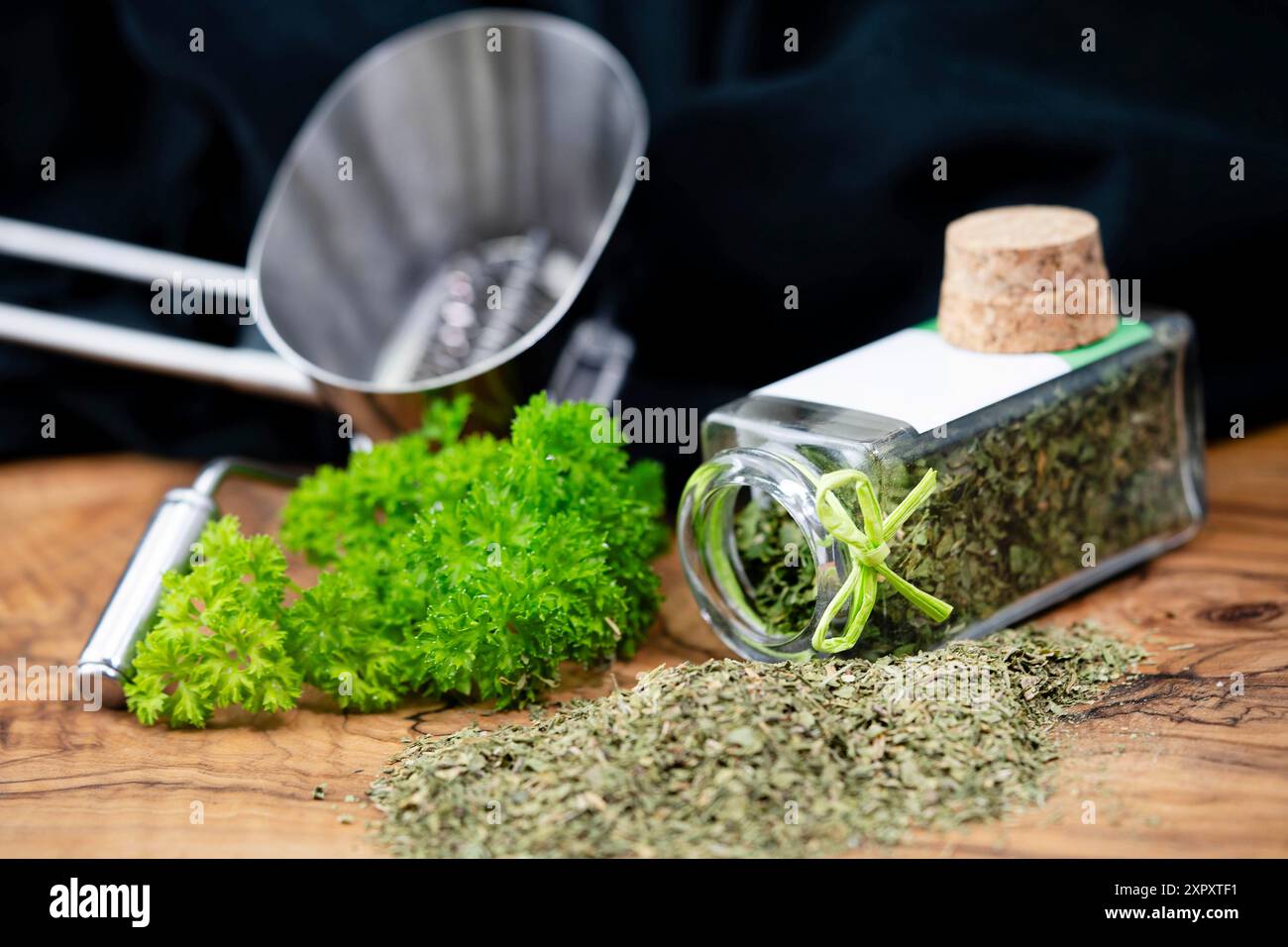 Curley leaf parsley, Parsley (Petroselinum crispum), fresh leaf and rubbed in a glass, with hebr mill Stock Photo