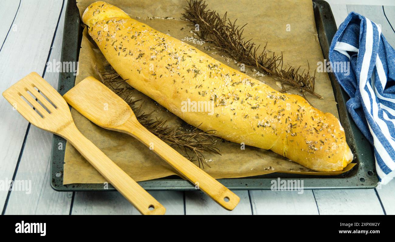 Rosemary bread on a baking tray with twigs of rosemary Stock Photo