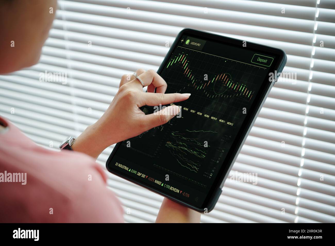 Analyzing Stock Market Trends using Tablet Technology Stock Photo