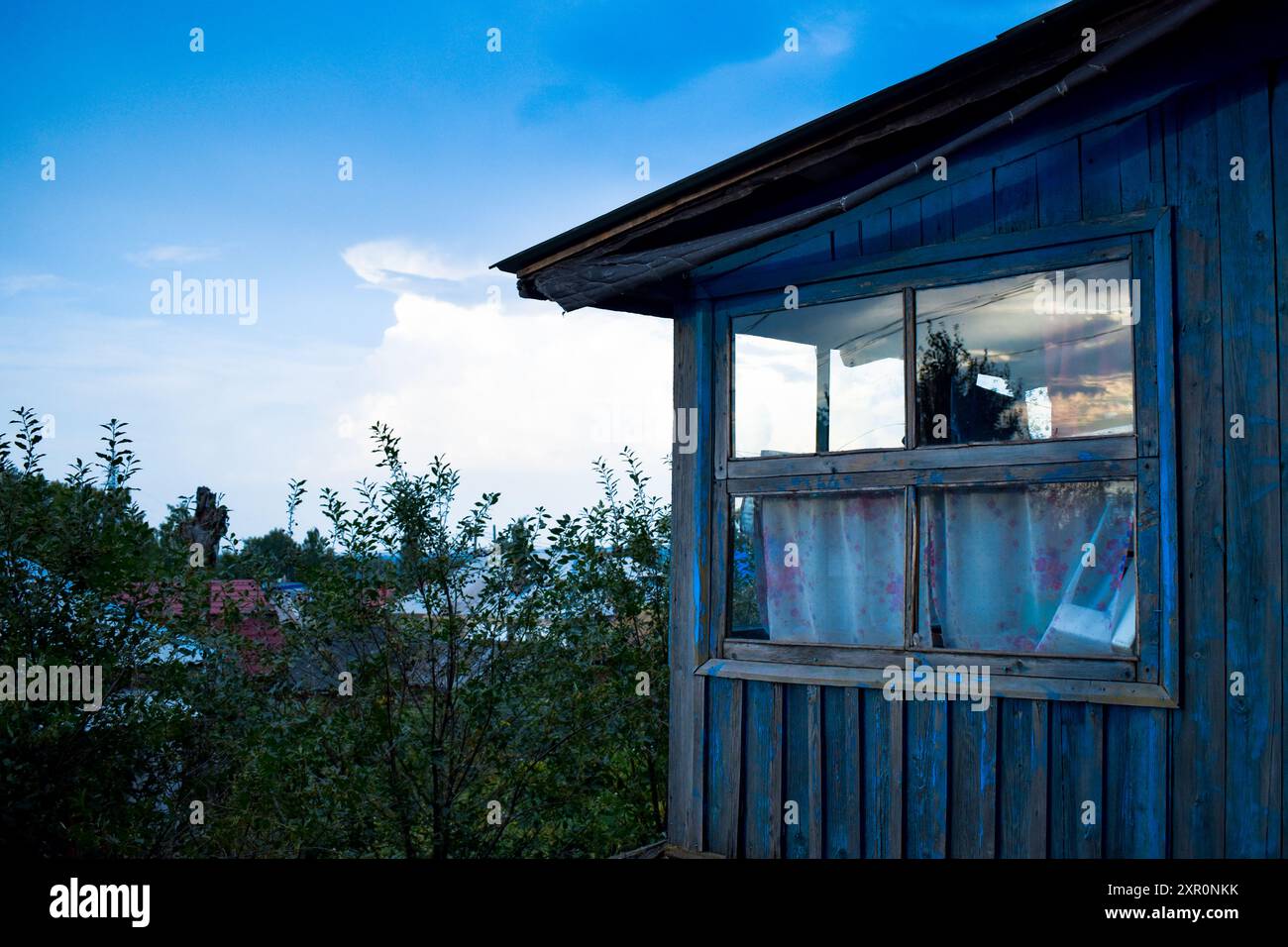 An image of an old wooden blue house with blue sky background Stock ...