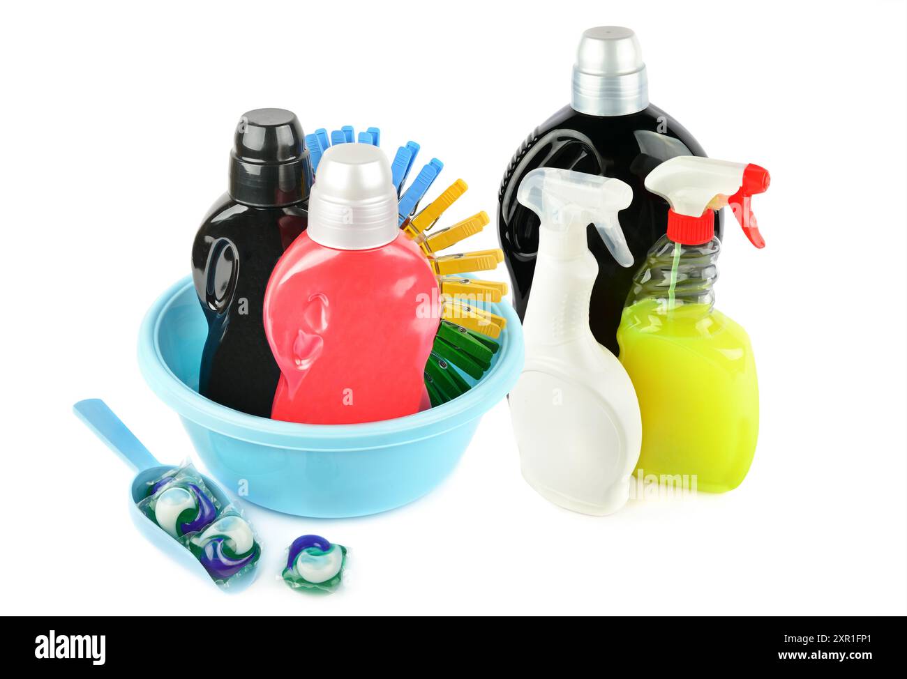 Bottles with household chemicals , washing basinand clothespins isolated on white background. Stock Photo