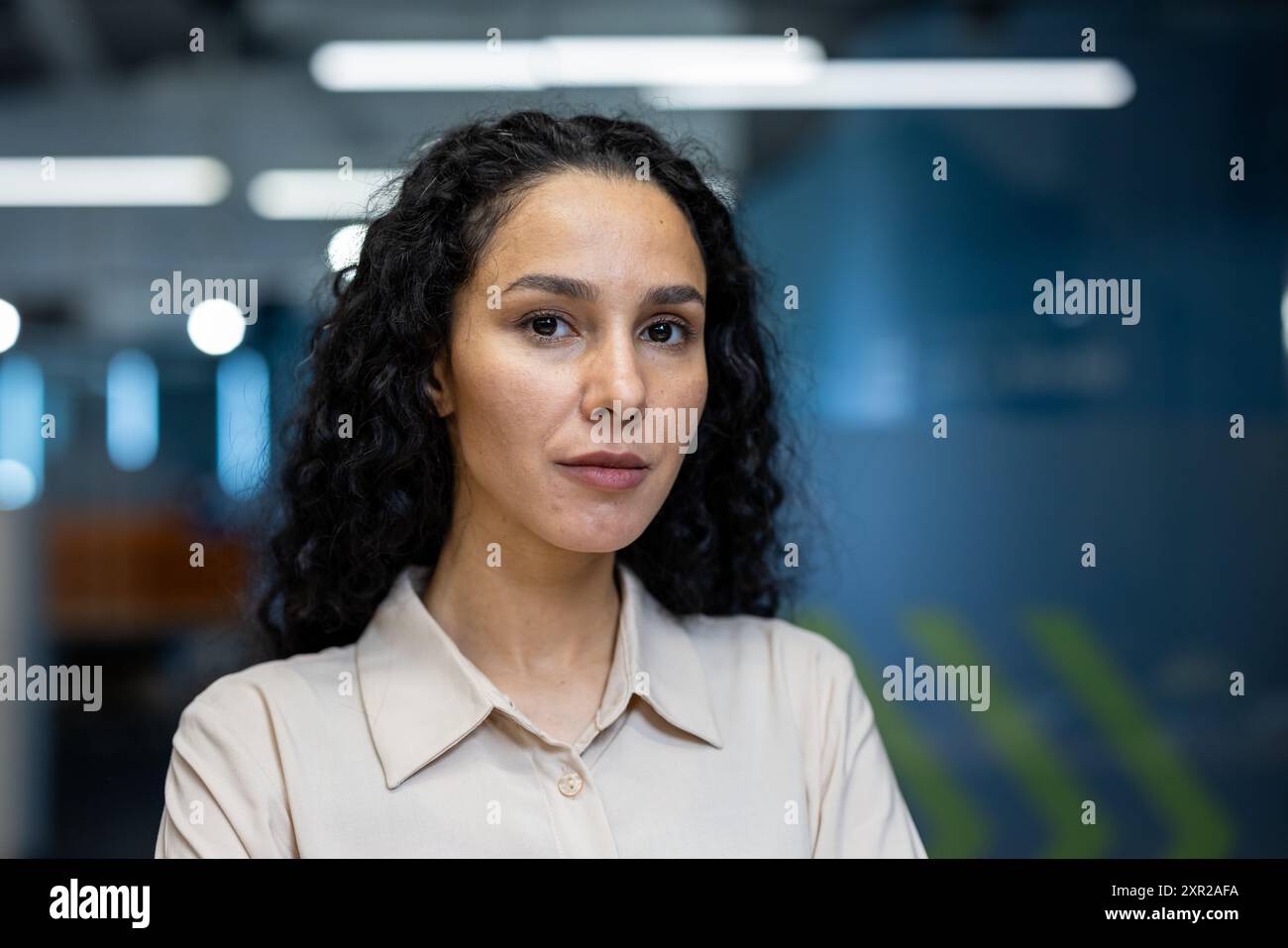 Serious woman curly hair beige hi-res stock photography and images - Alamy