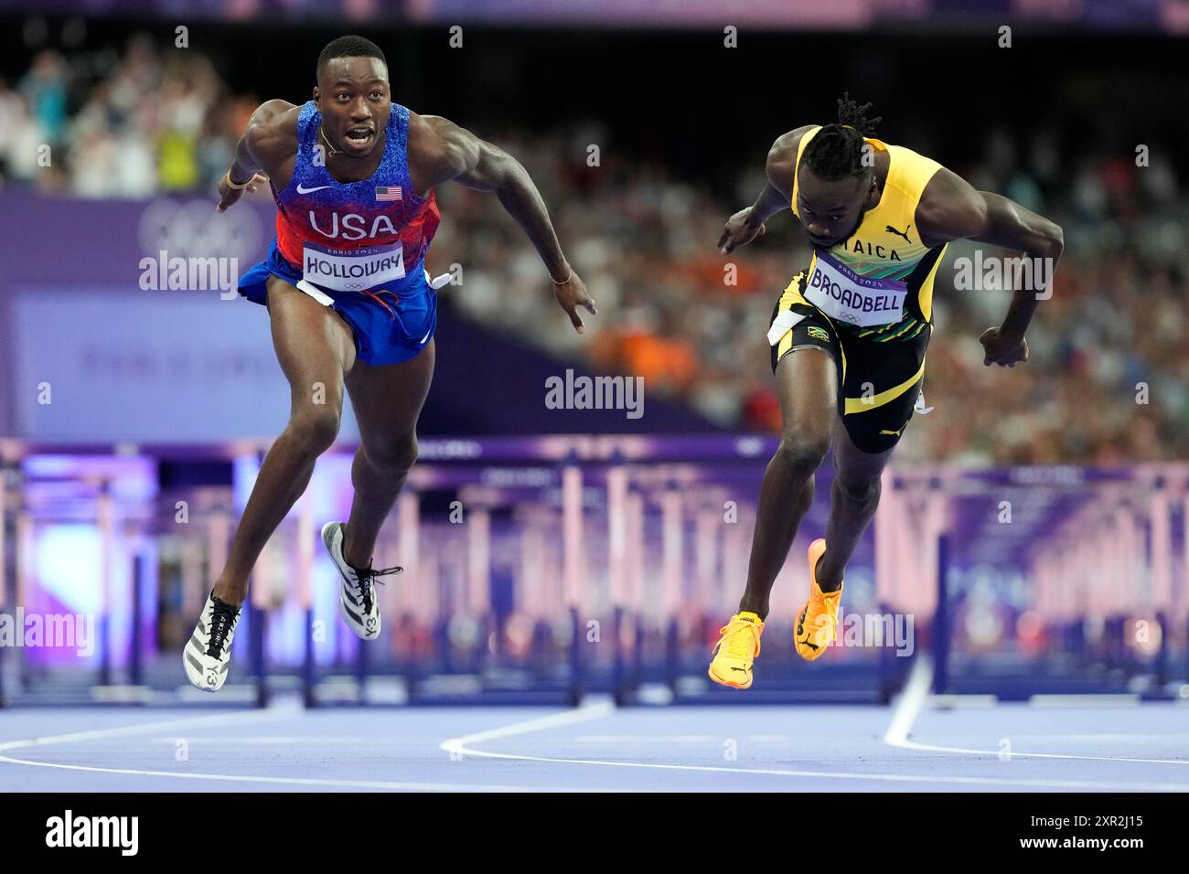 Grant Holloway, left, of the United States, wins the men's 110meters