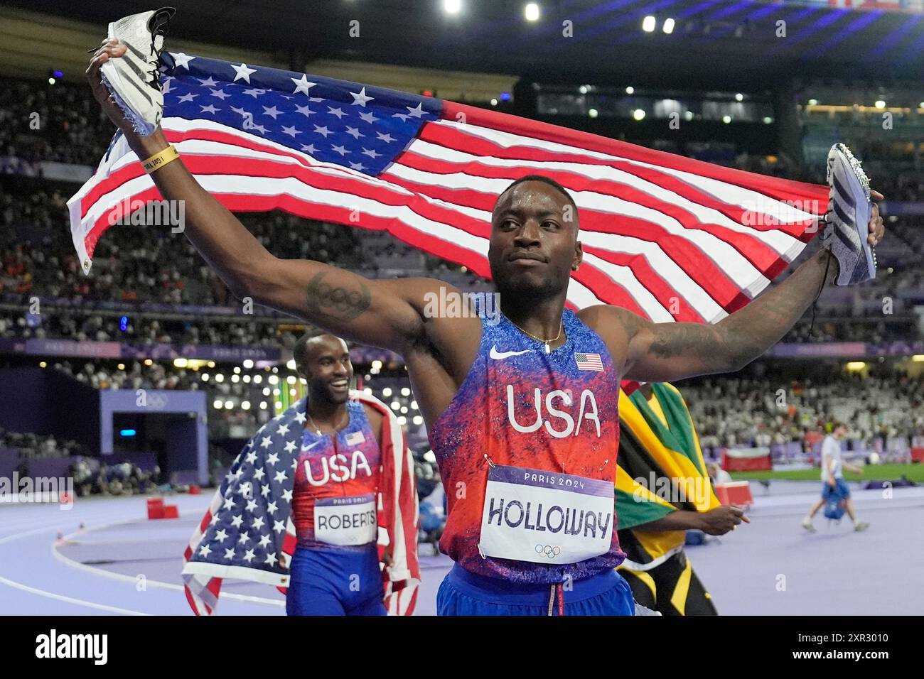 Grant Holloway, of the United States, celebrates after winning the men