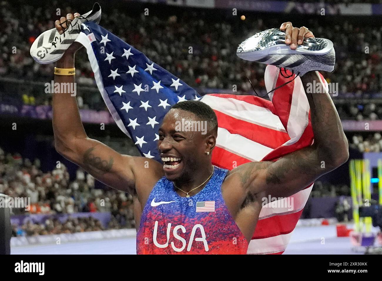 Grant Holloway, of the United States, celebrates after winning the men