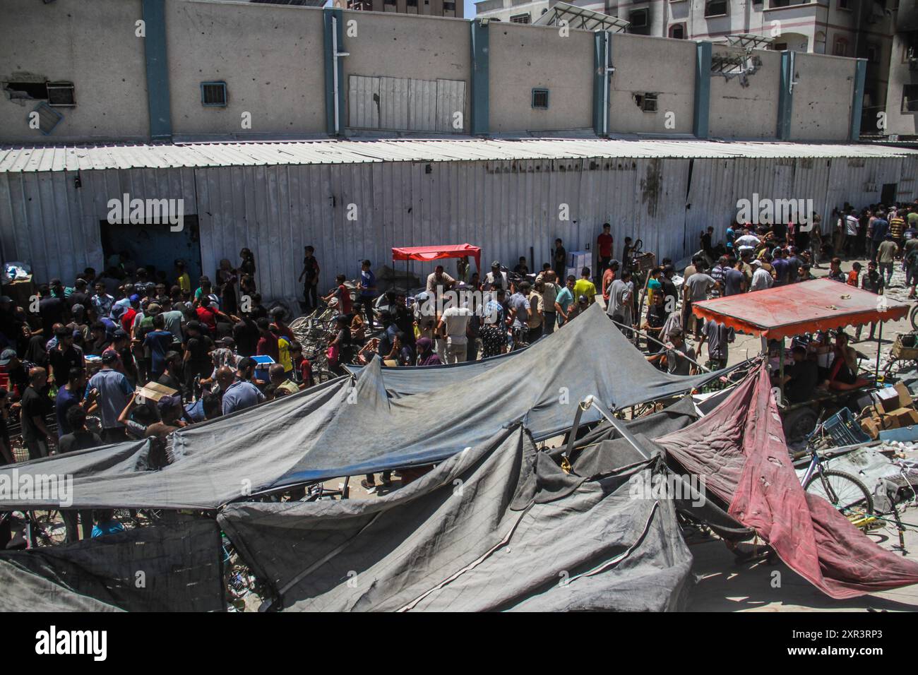 View of Jabalia Refugee Camp. 8th Aug, 2024. People gather to receive food aid ...