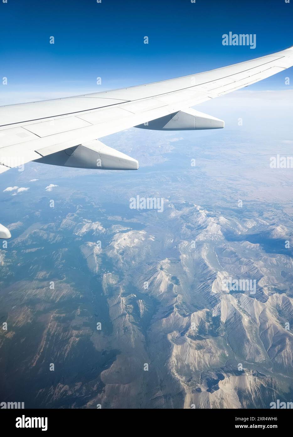 View of airplane wing mid flight Stock Photo - Alamy