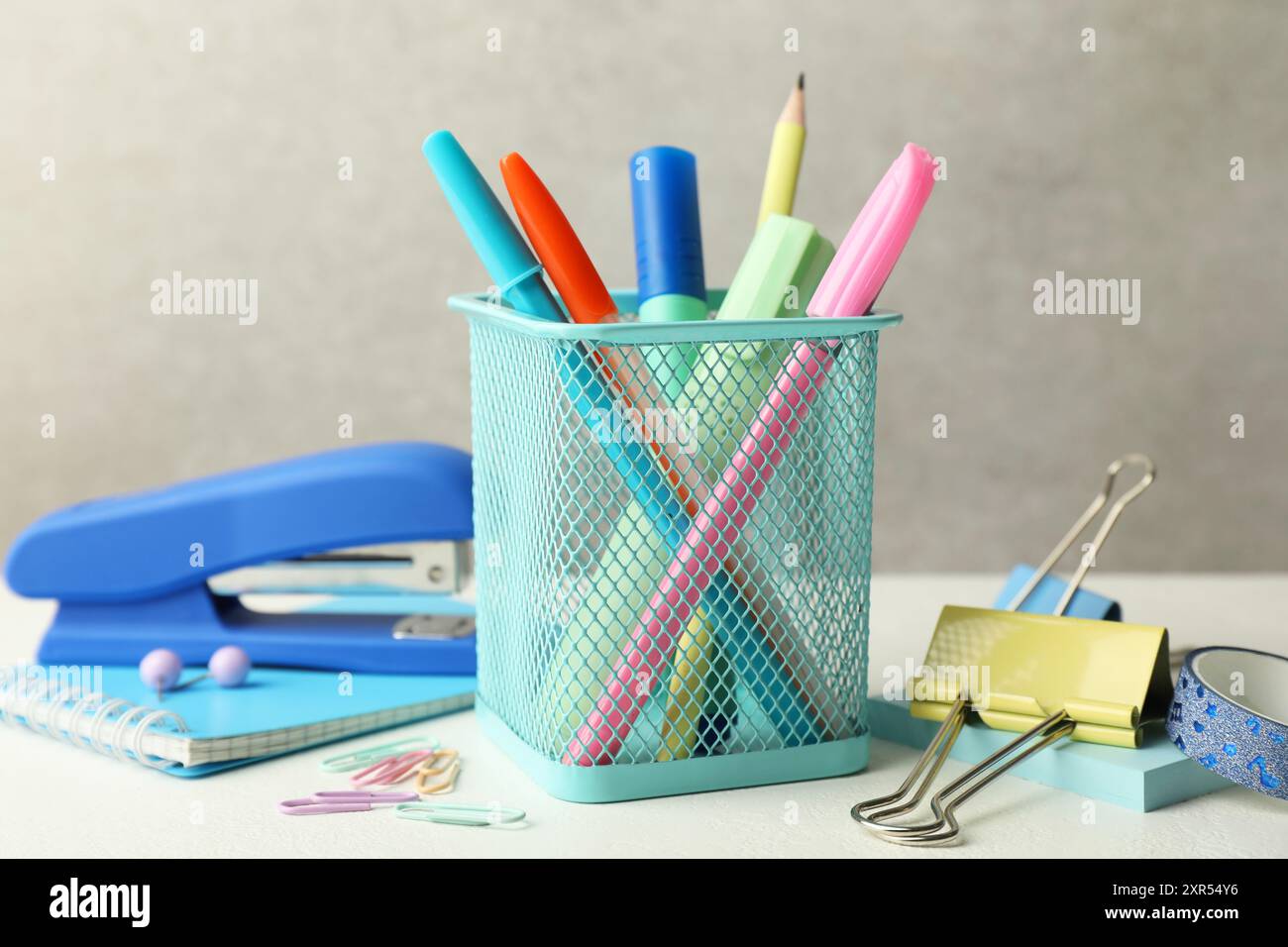 Stapler, holder and other different stationery on white table Stock Photo