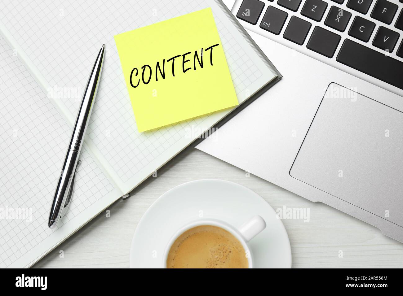 Note with word Content written in notebook on table. Workplace, top view Stock Photo