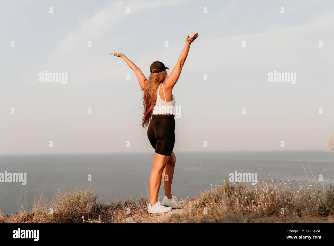 Woman Celebrating on a Clifftop Stock Photo
