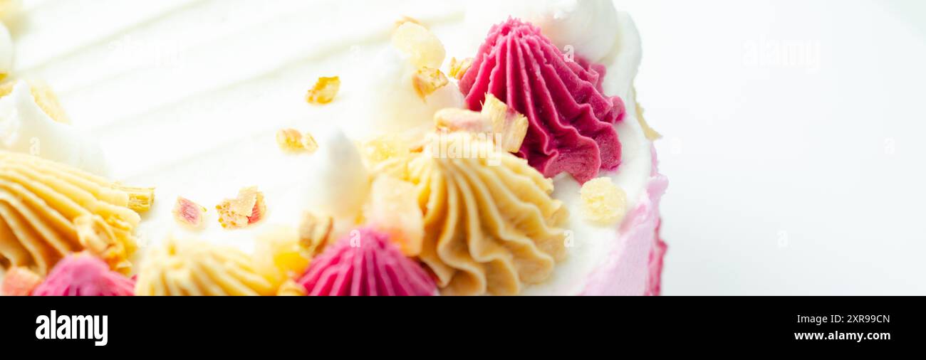 A cake with pink frosting and white frosting with a pink swirl on top ...