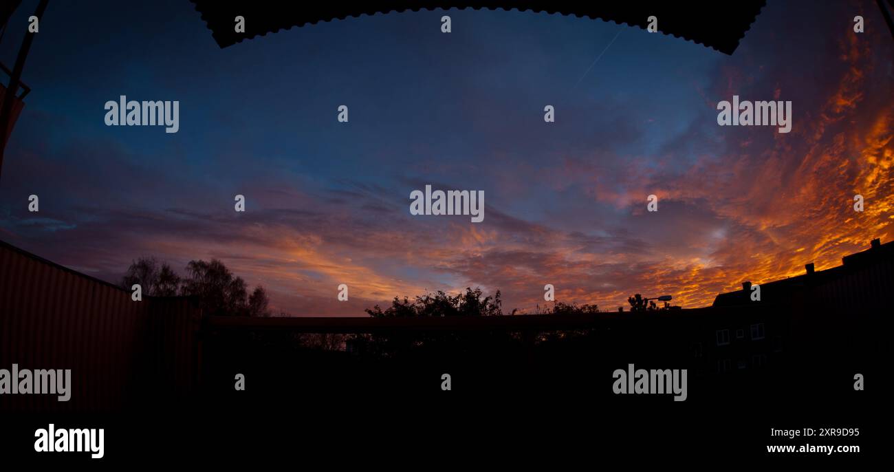 Wide angle view of sunset clouds from a balcony Stock Photo - Alamy
