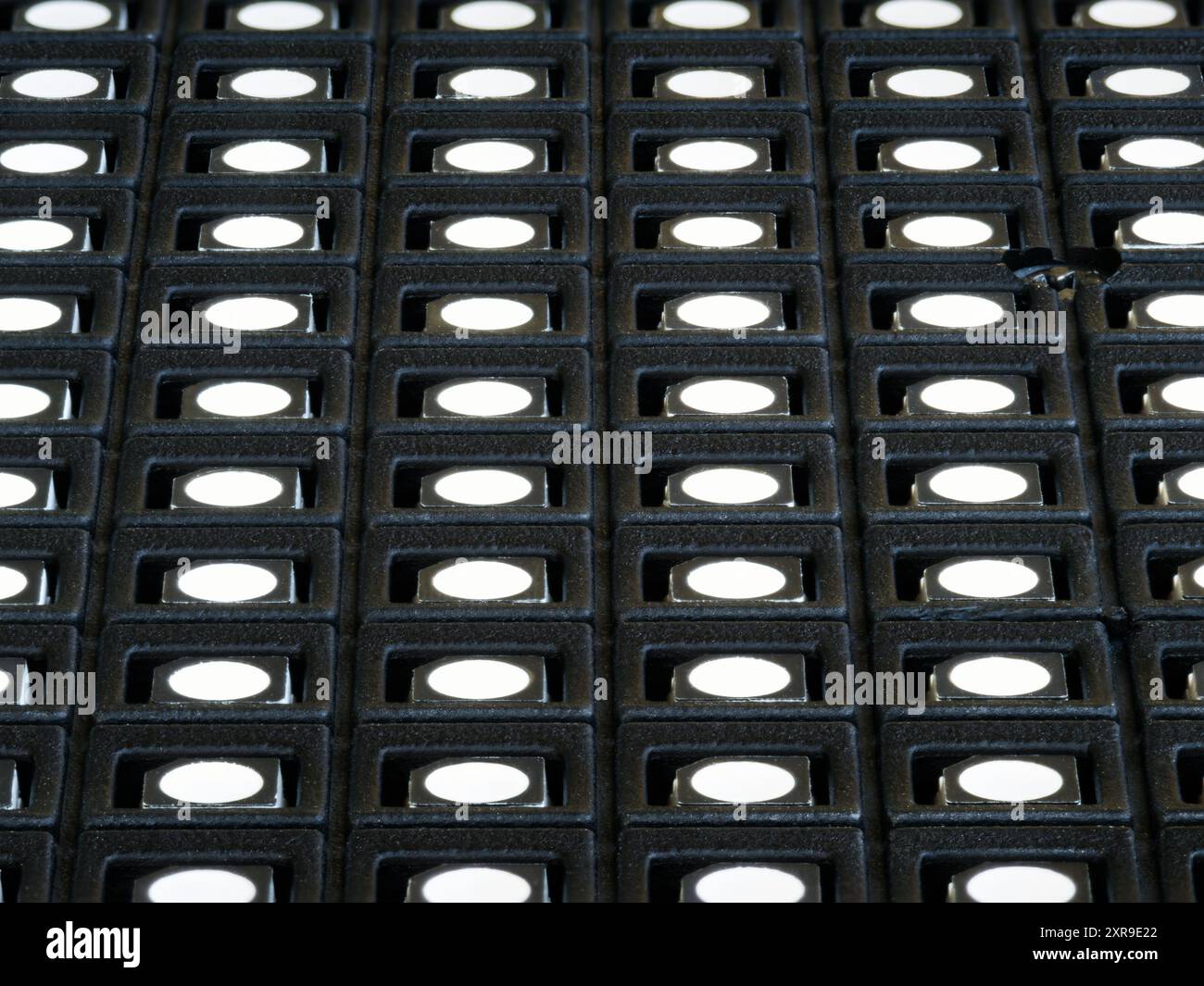 Macro shot of the surface of an LED screen module with rows of LEDs. Stock Photo
