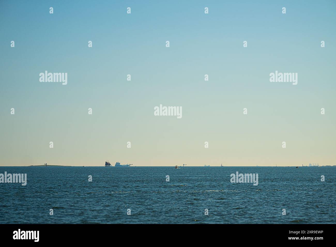 Sail ship and tanker ships on the horizon on a summer day Stock Photo ...