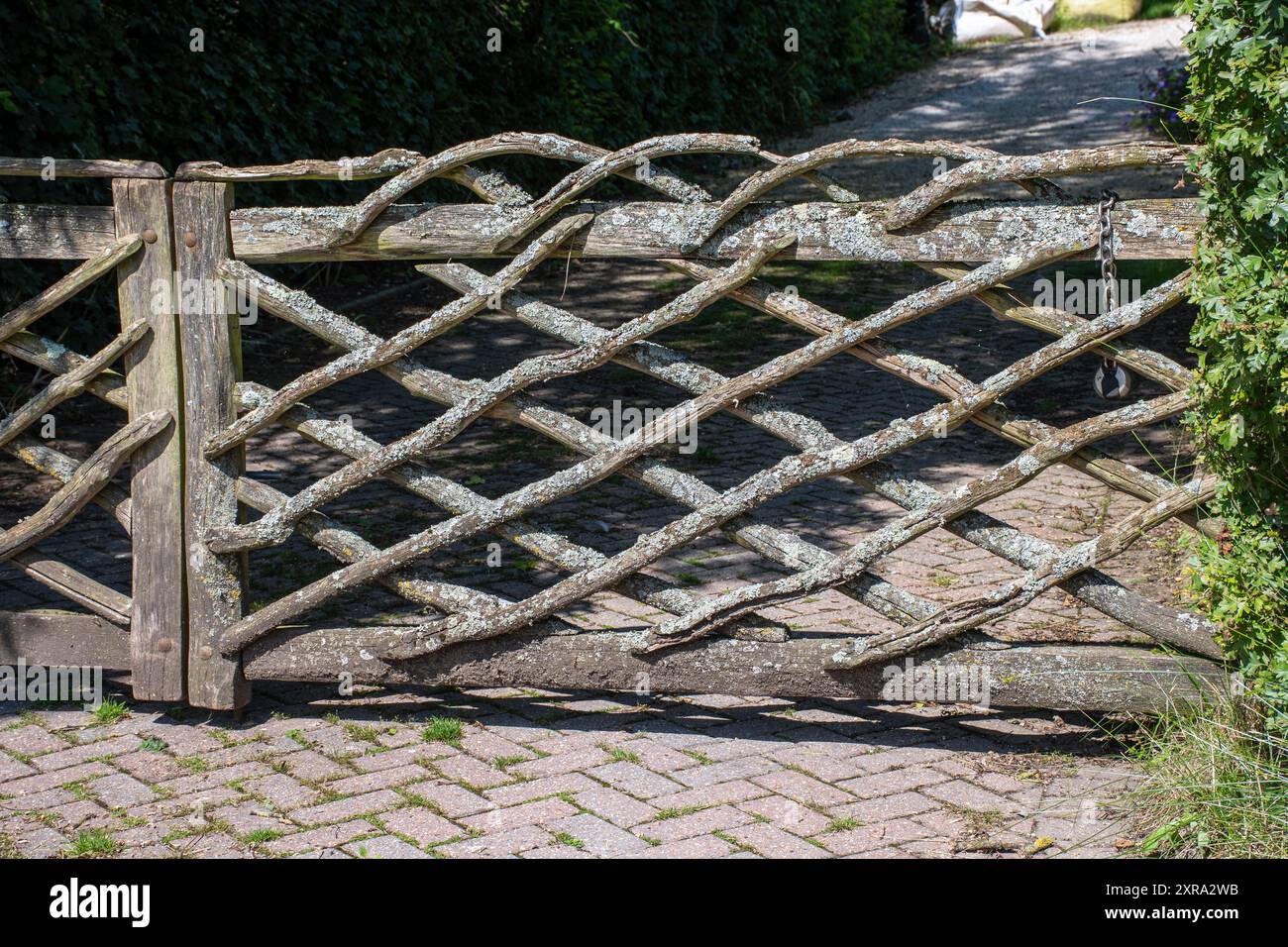 Rustic gate made of lichen covered tree branches or twigs Stock Photo ...