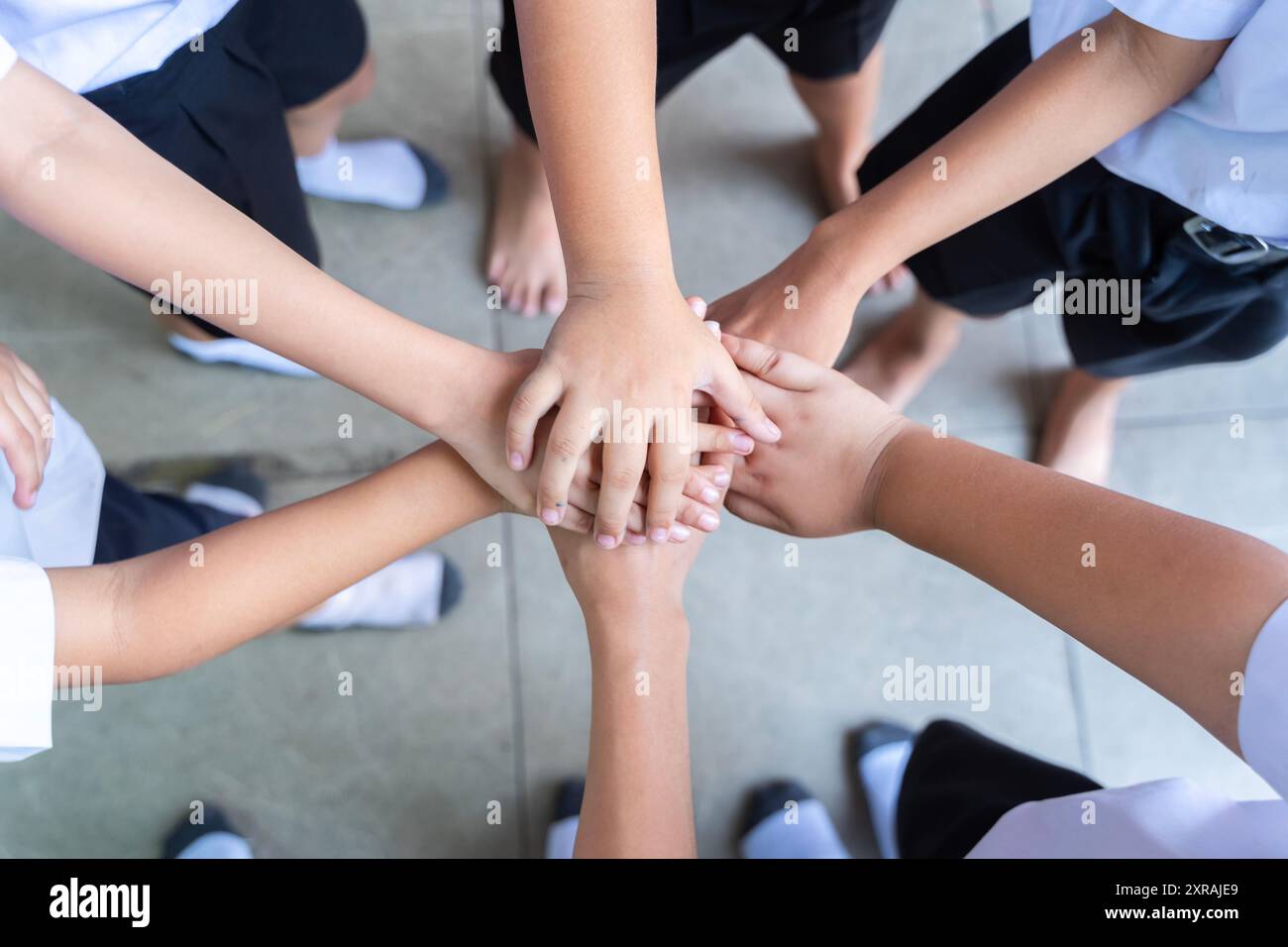 School children use handtohand coordination to combine power in activities. Friends putting