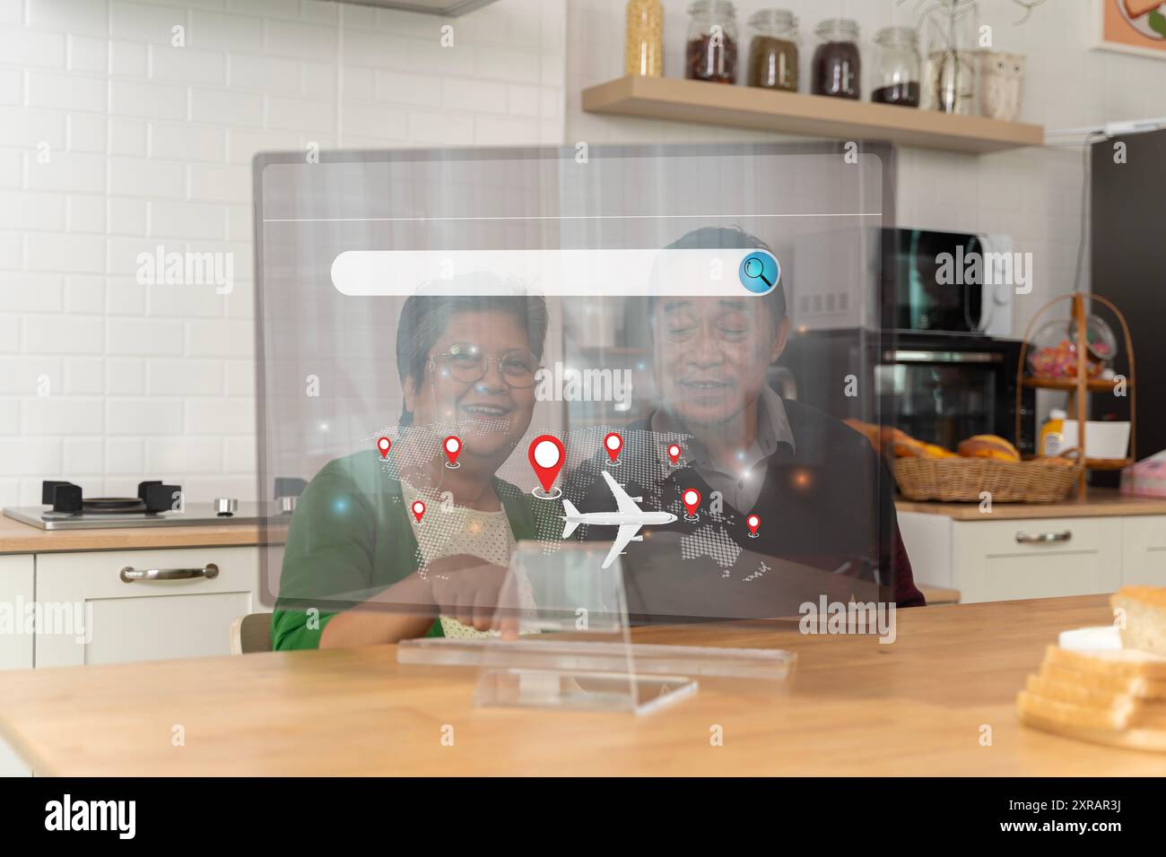 A senior couple looked at their laptop computers with interest and took notes in their notebooks. Plan a trip. White hair. New technology for the elde Stock Photo