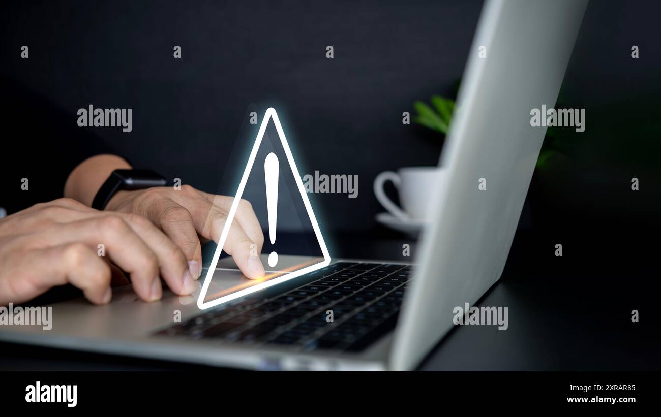 Businessman using computer laptop with triangle caution warning sing , Http 404 error not found page template concept. Triangle caution warning sing o Stock Photo