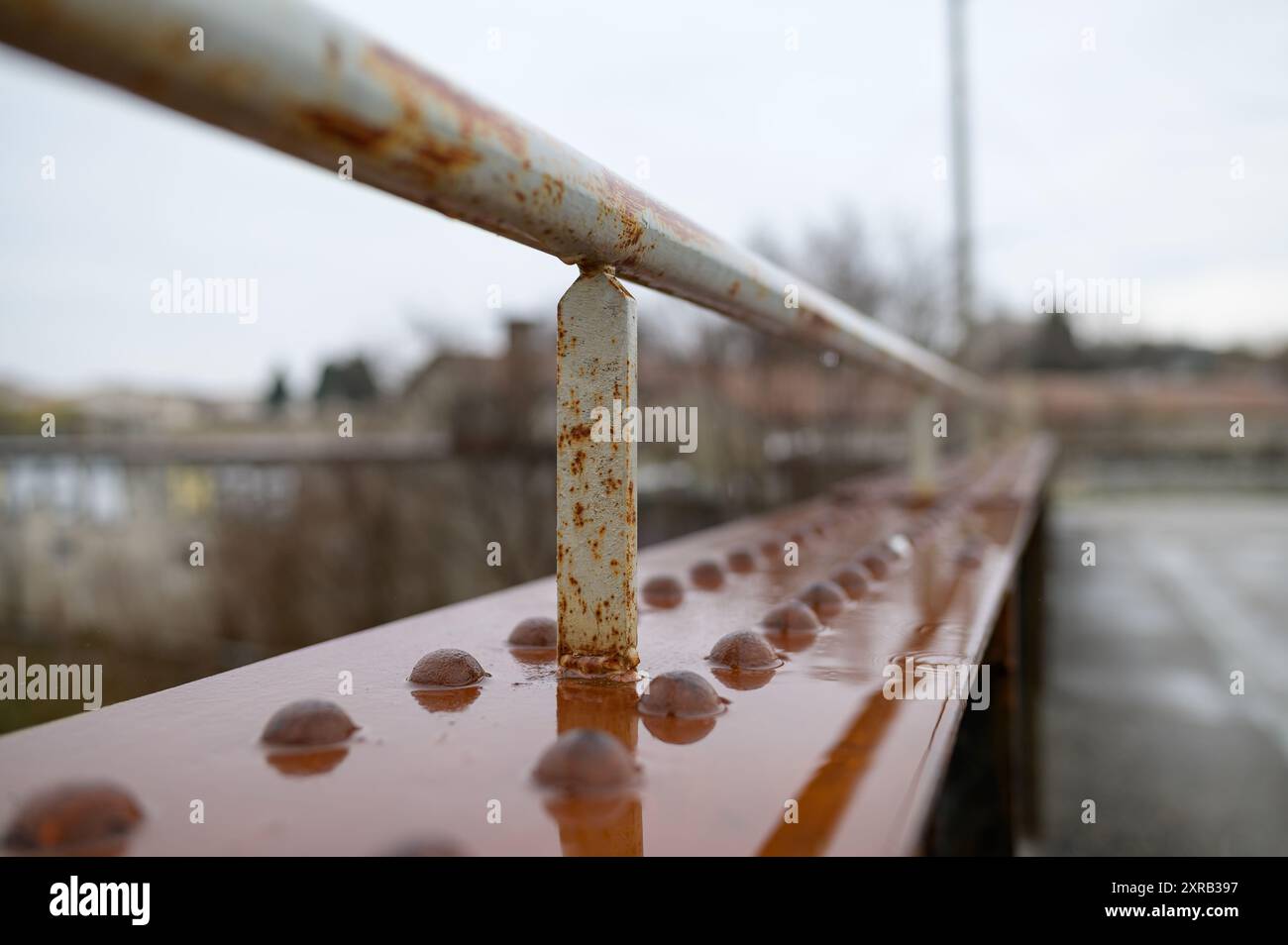 Old rusty wet railing of a small bridge, rainy day in winter Stock ...