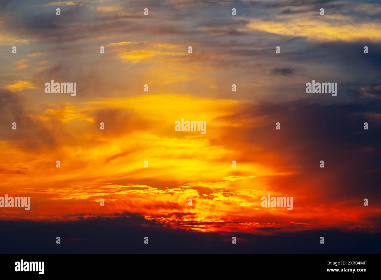 Beautiful sunset with a warm orange and yellow sky. The clouds are ...